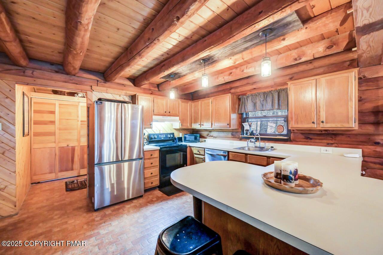 185 Whispering Pine Road Kunkletown, PA 18058 - Photo 10 of 65 a kitchen with stainless steel appliances wooden floor dining table and chairs