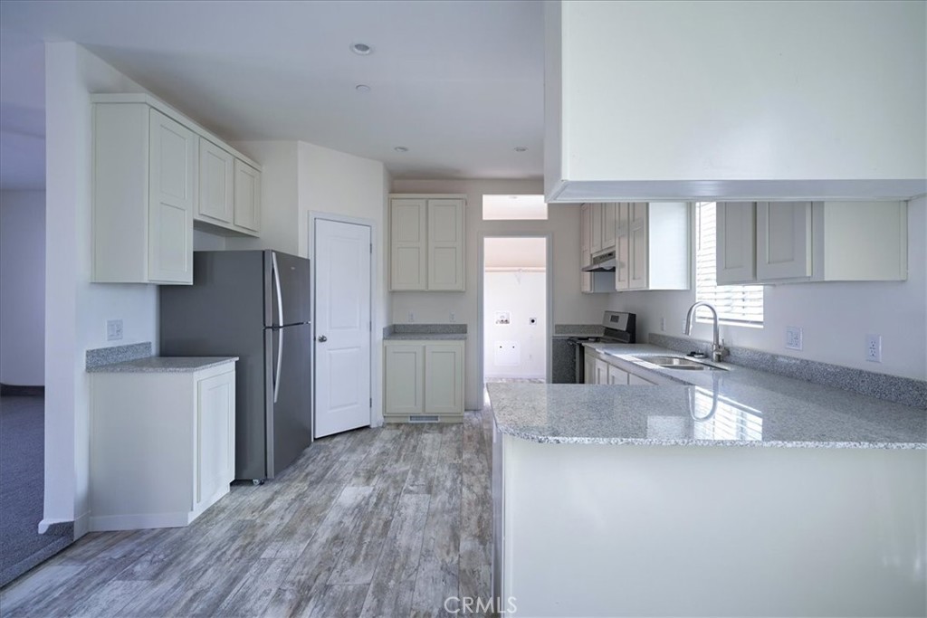 12594 Atsina Road Phelan, CA 92371 - Photo 11 of 37 a kitchen with refrigerator and cabinets