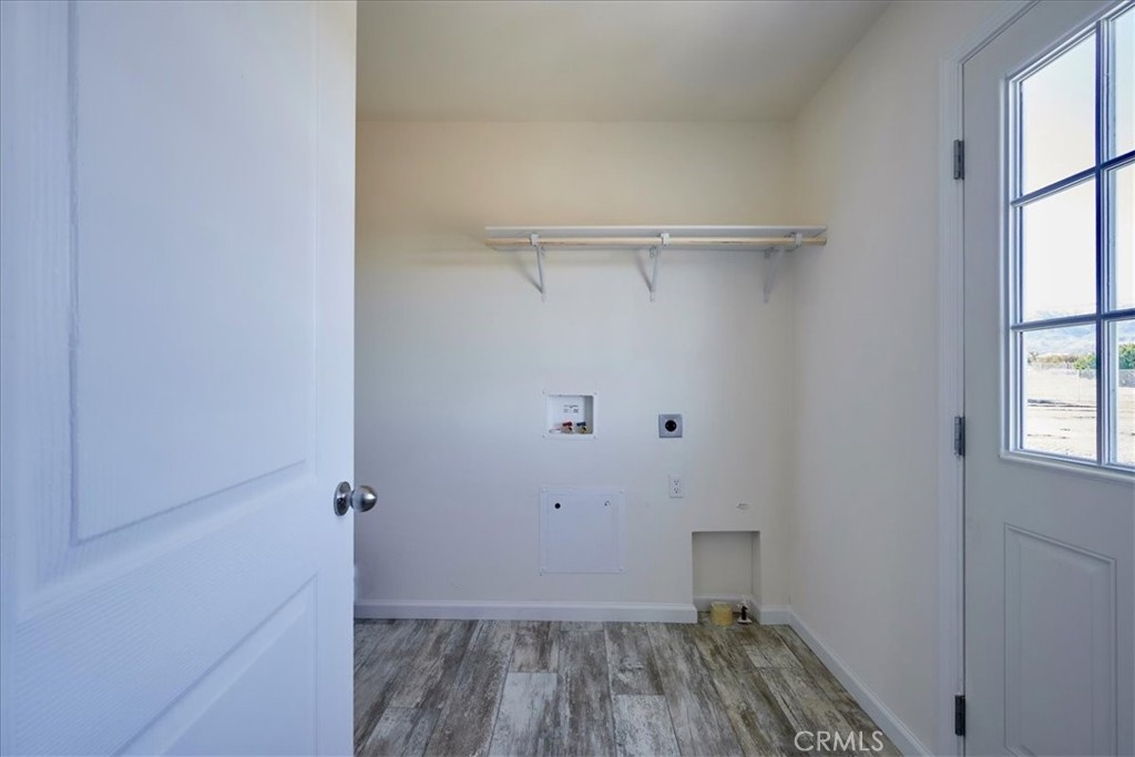 12594 Atsina Road Phelan, CA 92371 - Photo 14 of 37 a view of a room with wooden floor closet and windows