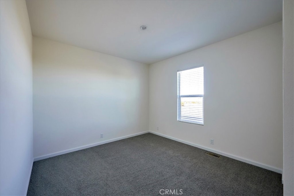 12594 Atsina Road Phelan, CA 92371 - Photo 24 of 37 an empty room with a window