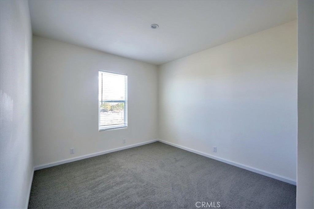 12594 Atsina Road Phelan, CA 92371 - Photo 29 of 37 an empty room with a window