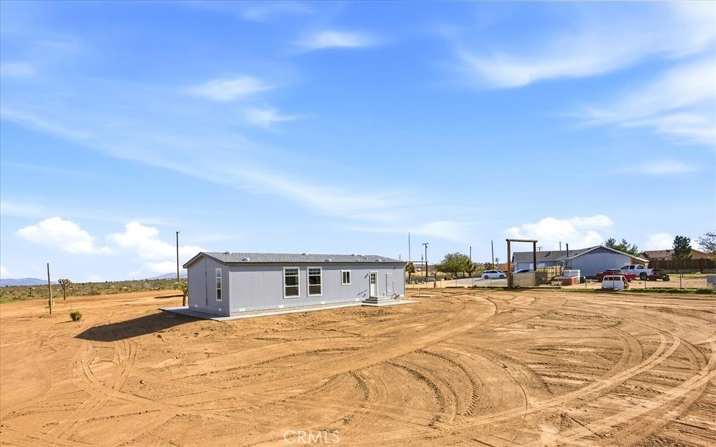 12594 Atsina Road Phelan, CA 92371 - Photo 34 of 37 a spacious bathroom with a large mirror and vanity