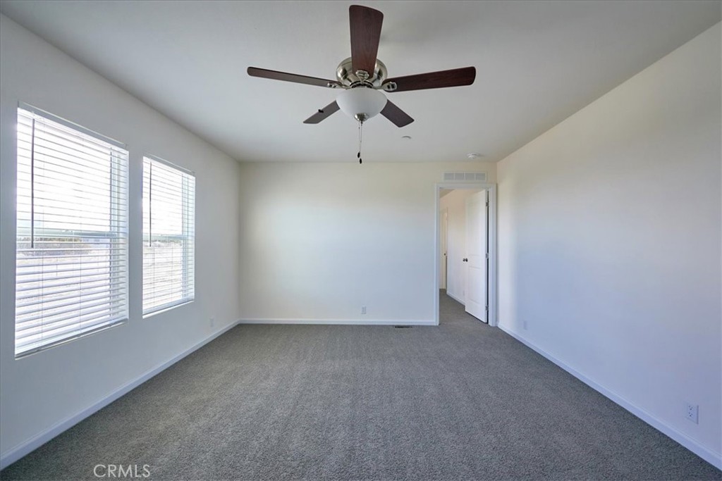 12594 Atsina Road Phelan, CA 92371 - Photo 7 of 37 a view of room with window and ceiling fan