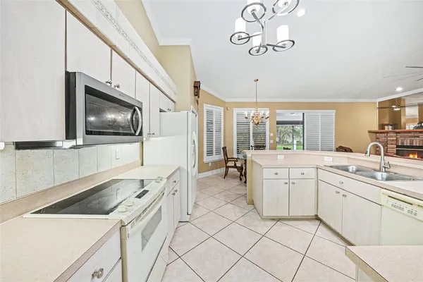 a kitchen with a sink cabinets and window