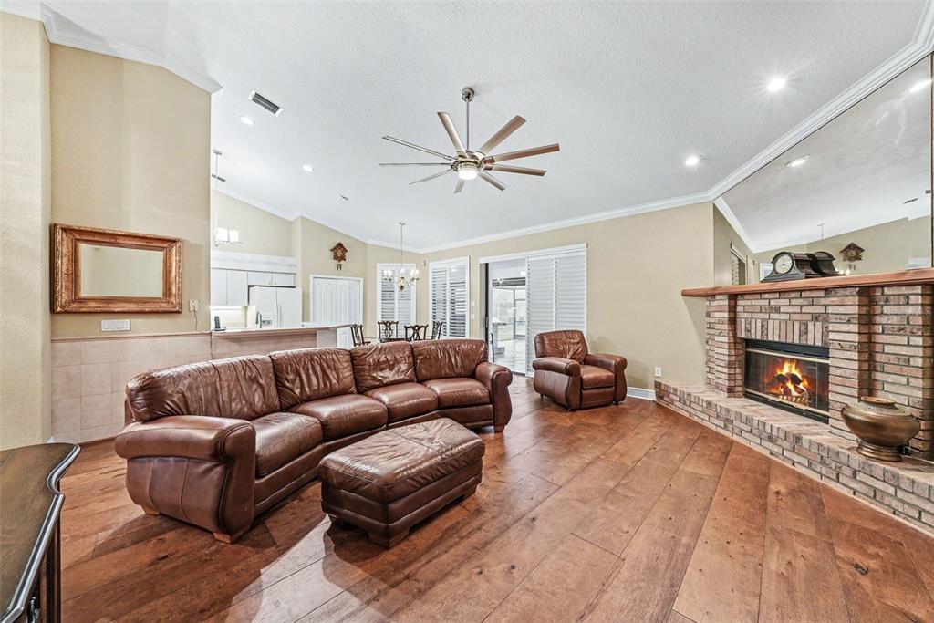 19216 Ridgelake Drive Lutz, FL 33549 - Photo 17 of 31 a living room with furniture a fireplace and a flat screen tv
