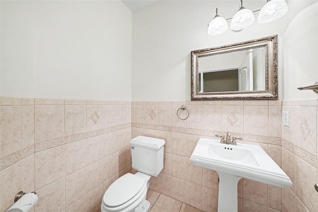 19216 Ridgelake Drive Lutz, FL 33549 - Photo 19 of 31 a bathroom with a toilet a sink and mirror