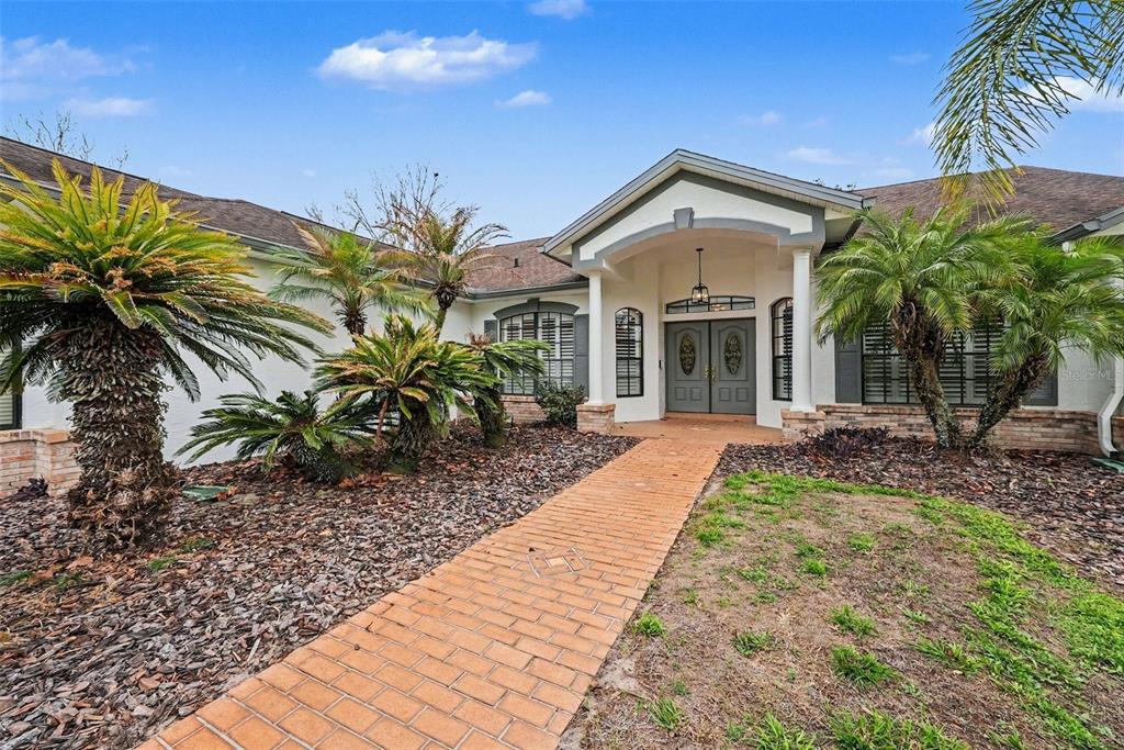 19216 Ridgelake Drive Lutz, FL 33549 - Photo 2 of 31 a front view of a house with garden