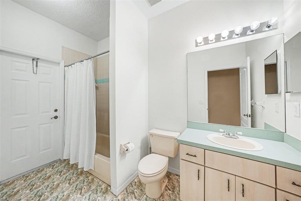 19216 Ridgelake Drive Lutz, FL 33549 - Photo 23 of 31 a bathroom with a granite countertop sink toilet and shower