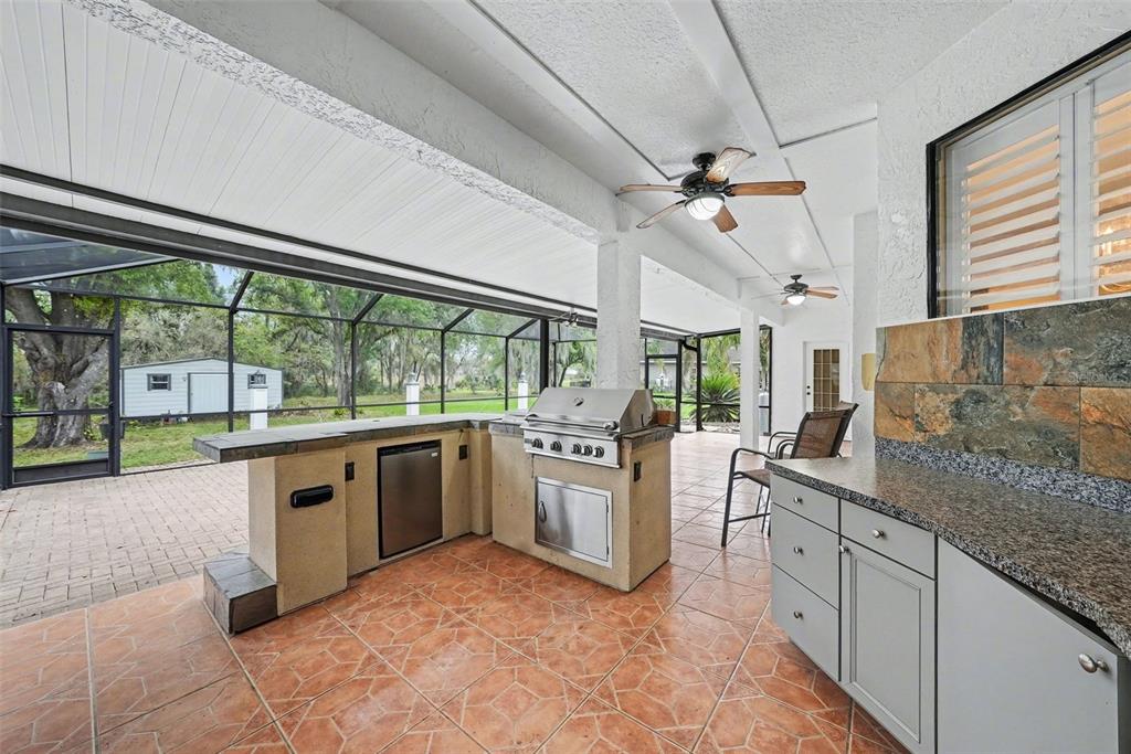 19216 Ridgelake Drive Lutz, FL 33549 - Photo 26 of 31 a kitchen with stainless steel appliances granite countertop a stove and cabinets