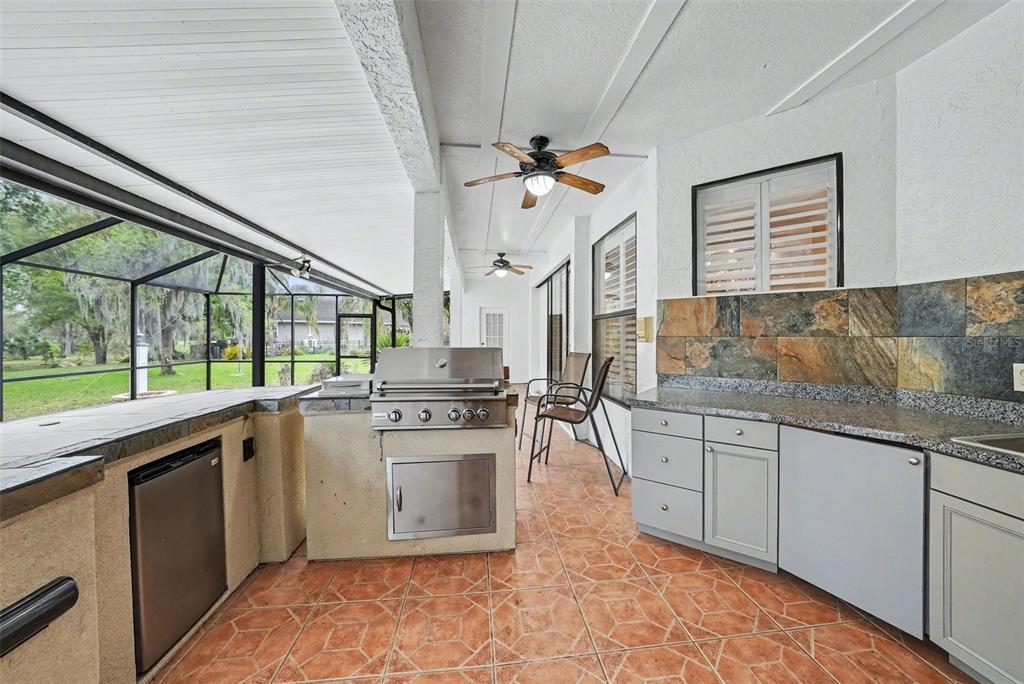19216 Ridgelake Drive Lutz, FL 33549 - Photo 27 of 31 a kitchen with stainless steel appliances granite countertop a stove a sink and a refrigerator