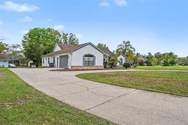 a view of house with outdoor space and garden
