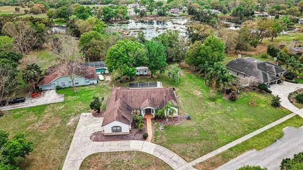 an aerial view of a house with a garden and trees