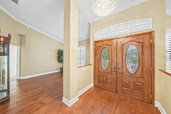 a view of an entryway with wooden floor