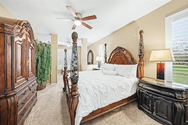 a bedroom with a large bed and a chandelier