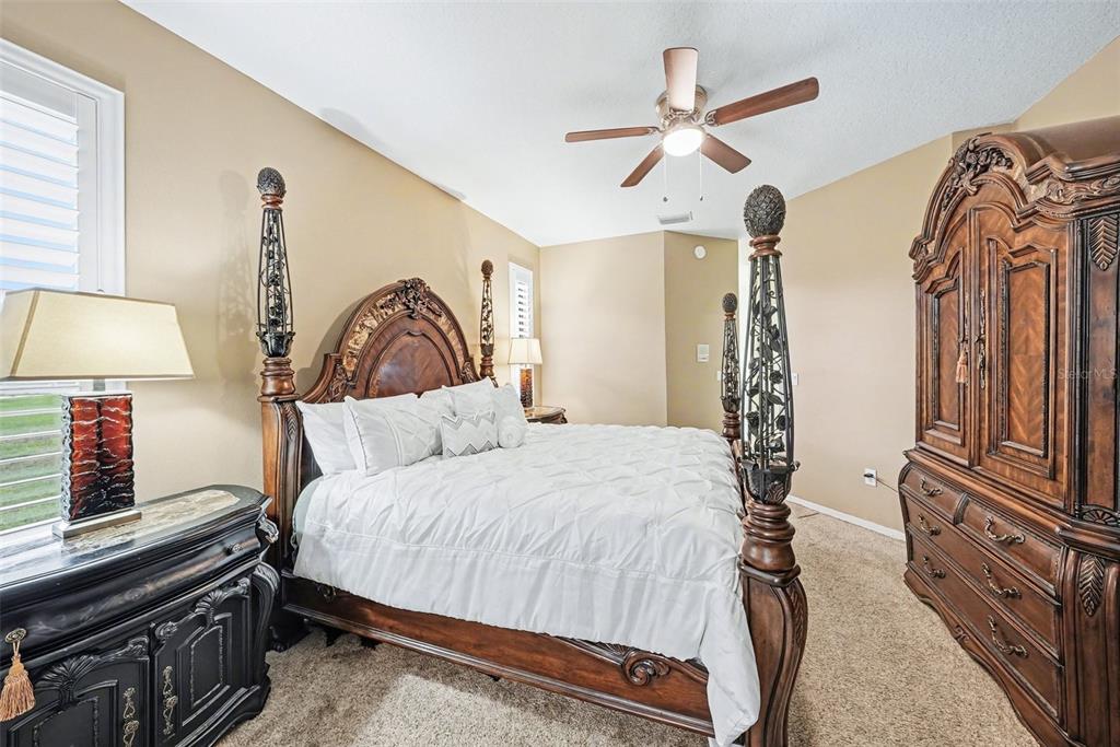 19216 Ridgelake Drive Lutz, FL 33549 - Photo 7 of 31 a bedroom with a bed and a lamp on the dresser