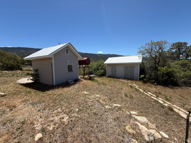 10000 North 6730th East Spring City, UT 84662 - Photo 24 of 31 Two detached structures featuring light-colored siding and corrugated metal roofs