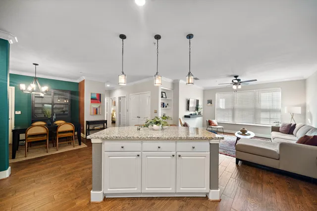 a view of living room with granite countertop furniture and wooden floor