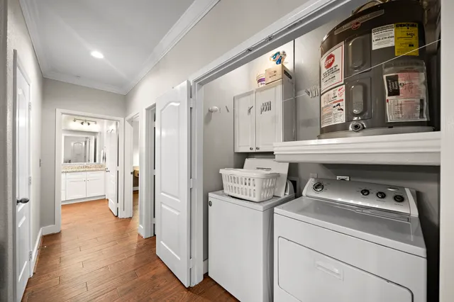 a view of washer and dryer with bathroom in the background