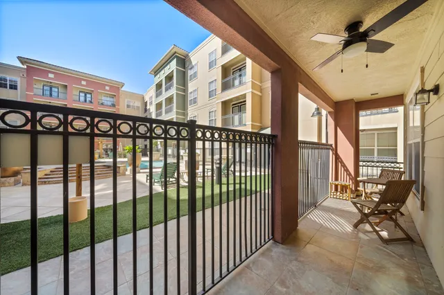 a view of a balcony with furniture and a ceiling fan