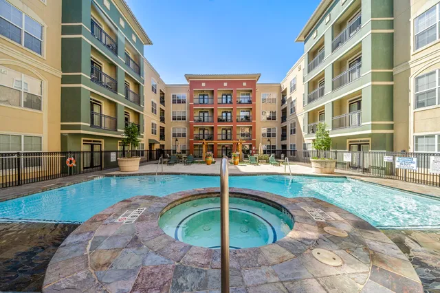a swimming pool with outdoor seating and yard