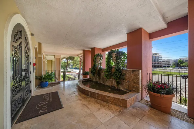 a building outdoor space with patio furniture and potted plants