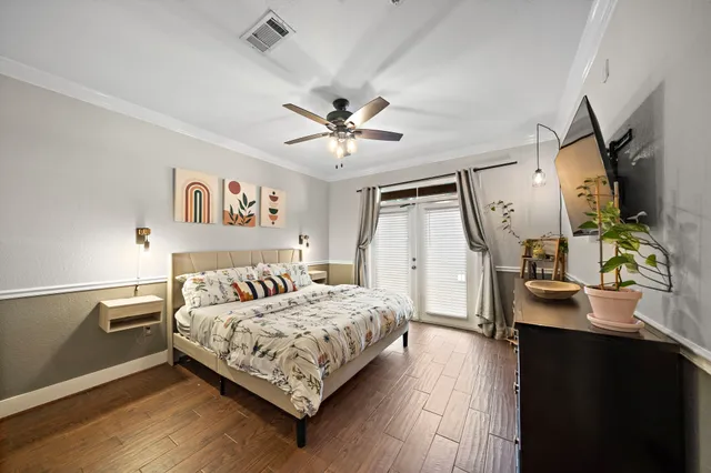 a bedroom with a bed and a chandelier