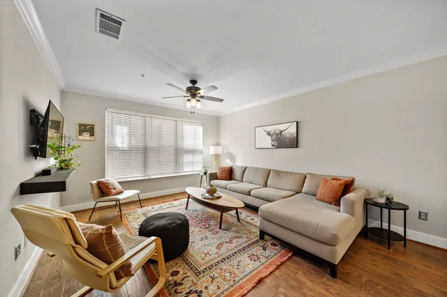 a living room with furniture a chandelier and a window