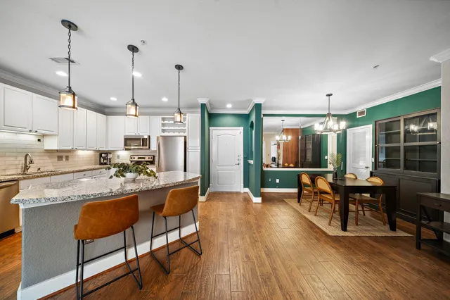 a large kitchen with a table and chairs