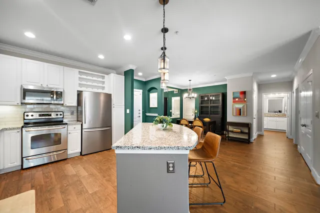 a kitchen with sink refrigerator and microwave