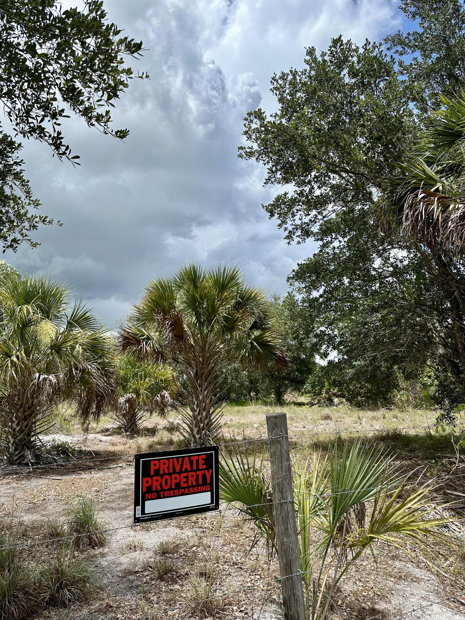 1701 Cabbage Wood Road Okeechobee, FL 34974 - Photo 12 of 16 a view of street with sign on the side of the road