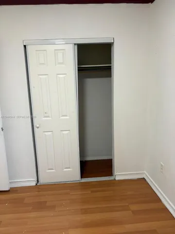 a view of an empty room and glass door