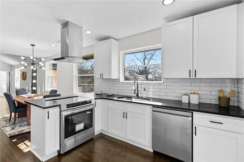 a kitchen with a sink stove and cabinets