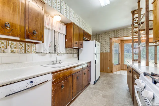 a kitchen with stainless steel appliances granite countertop a sink and a stove