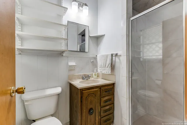 a bathroom with a sink toilet and shower