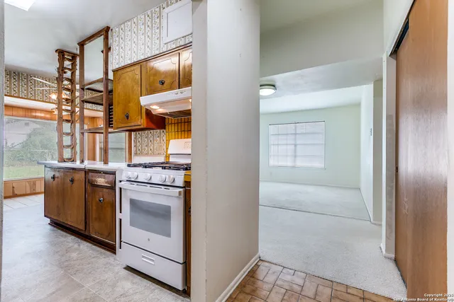 a kitchen with stainless steel appliances granite countertop a stove and a refrigerator