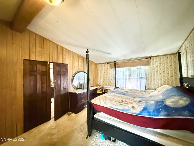 a spacious bathroom with a granite countertop sink a toilet a mirror and bathtub