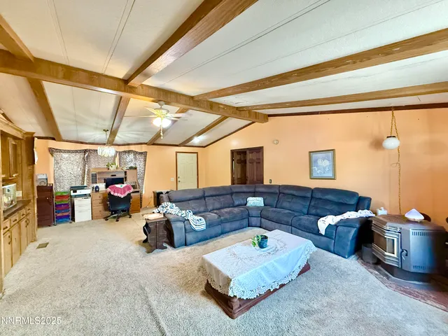 a kitchen with stainless steel appliances granite countertop a stove a sink dishwasher and a refrigerator with wooden floor