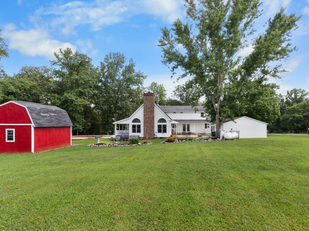 930 Roberts Road Clarksville, TN 37040 - Photo 54 of 67 a front view of a house with a garden and trees