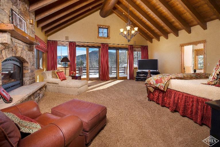 308 Bearden Road Edwards, CO 81632 - Photo 7 of 23 a spacious bedroom with a bed couch and a fireplace