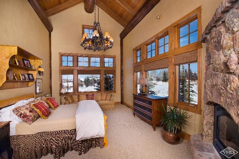 308 Bearden Road Edwards, CO 81632 - Photo 9 of 23 a bedroom with a large bed a flat tv screen and a book shelf