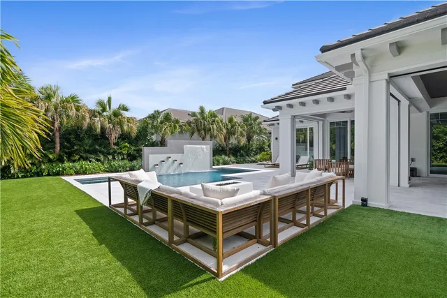 a view of a house with backyard and a patio
