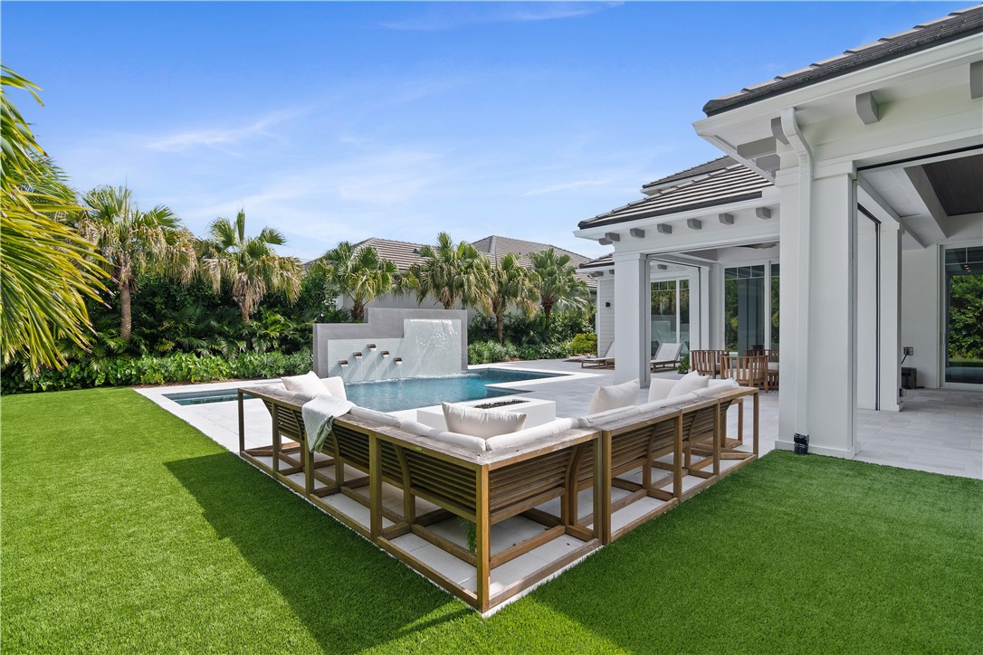 918 Surfsedge Way Indian River Shores, FL 32963 - Photo 18 of 32 a view of a house with backyard and a patio