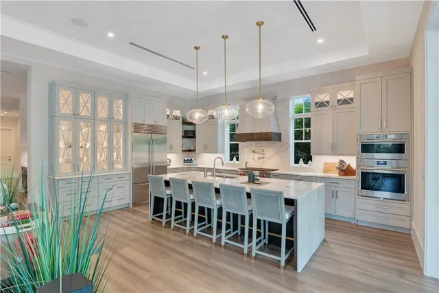 a kitchen with stainless steel appliances granite countertop a stove and a wooden floors