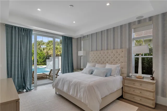 a bedroom with a large bed and a window