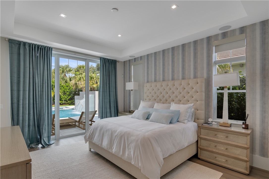 918 Surfsedge Way Indian River Shores, FL 32963 - Photo 10 of 32 a bedroom with a large bed and a window