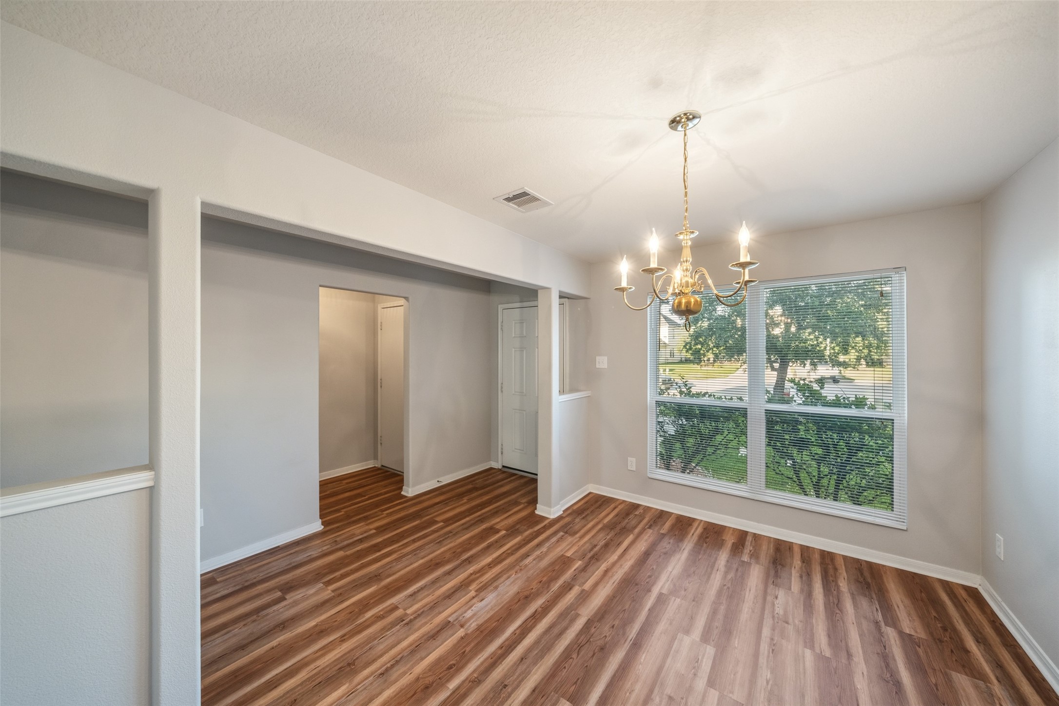 16820 Infield Court Conroe, TX 77385 - Photo 9 of 44 a view of a room with wooden floor exposed radiator and windows