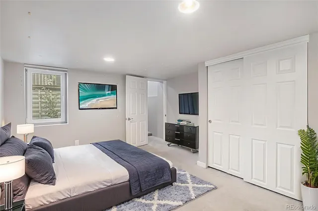 a bedroom with a bed and a couch