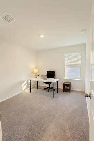 a living room with furniture and a lamp
