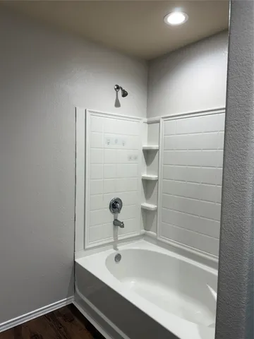 a bathroom with a bathtub and shower