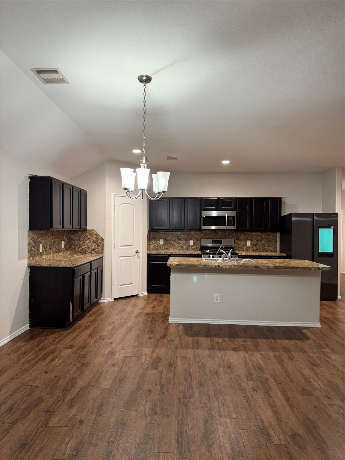 15415 Bosque Viejo Trail Channelview, TX 77530 - Photo 4 of 20 a large kitchen with kitchen island a sink stainless steel appliances and white cabinets